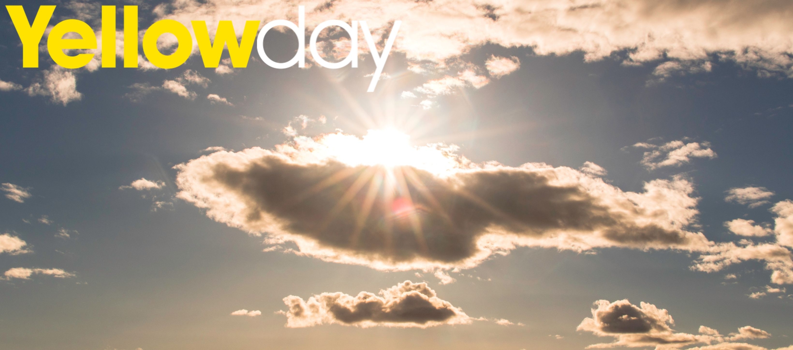 Stress Awareness Month Image shows the sun peeking out behind a cloud with blue sky behind. Yellowday logo in top right corner.